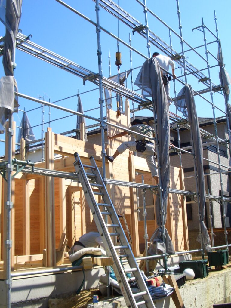 板倉造りの建て方で柱と板壁を組み上げている様子