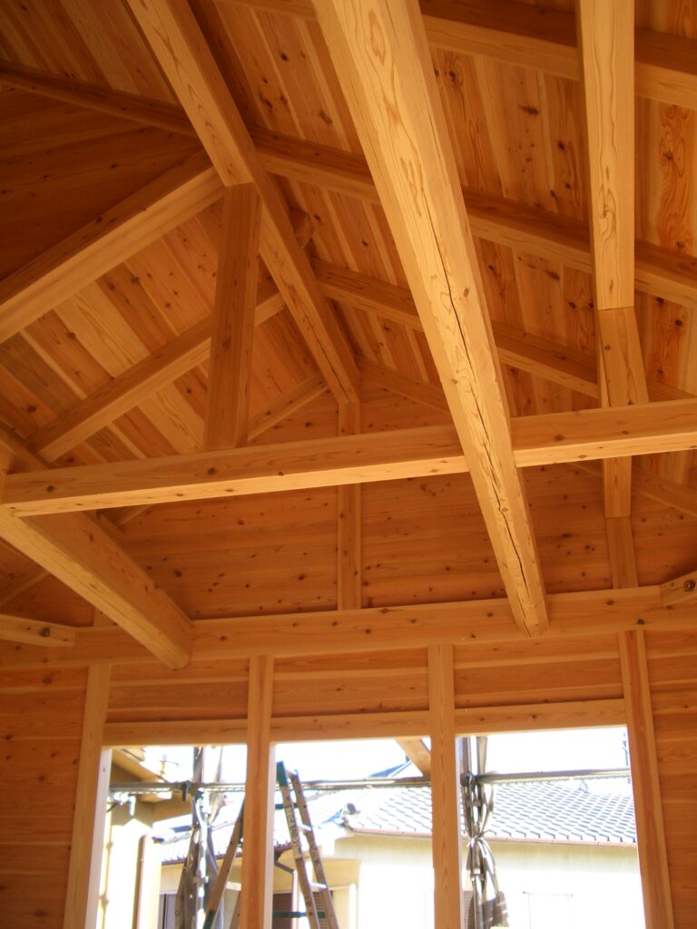 板倉造りの小屋組み内部。杉板の壁と梁・垂木が見える