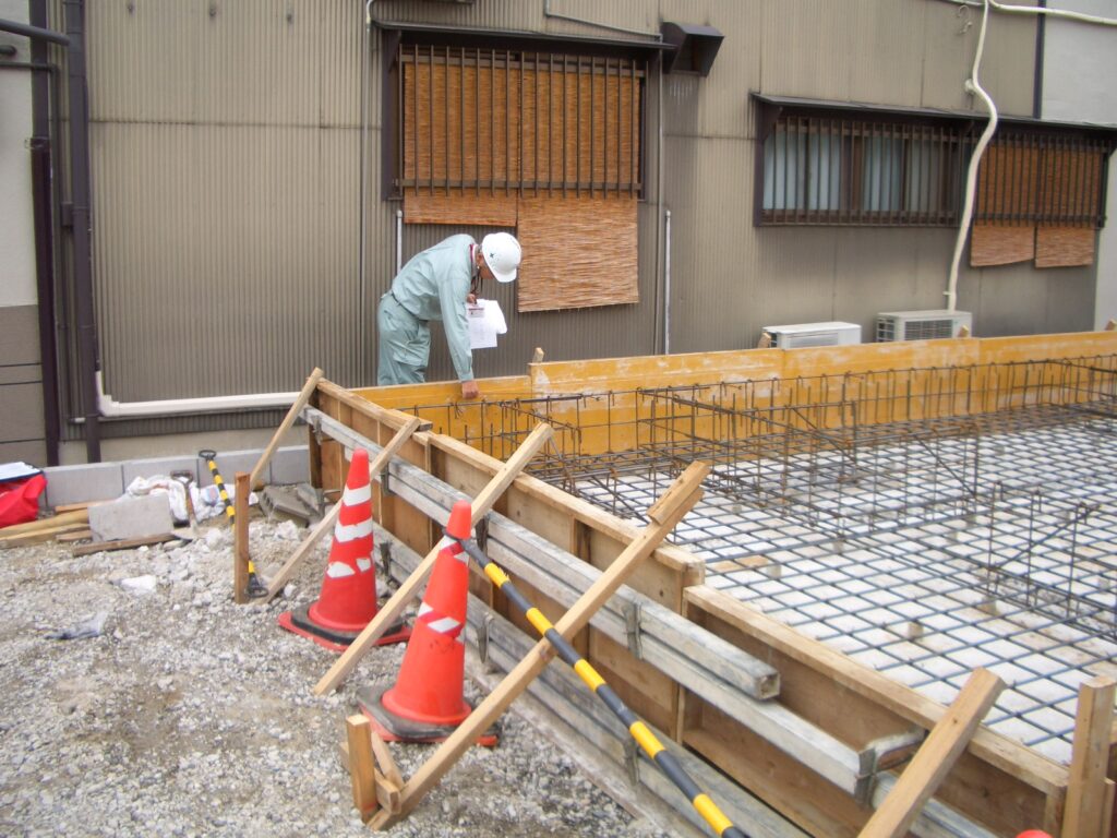 住宅瑕疵保険の配筋検査で検査員が鉄筋の施工状態を確認している様子